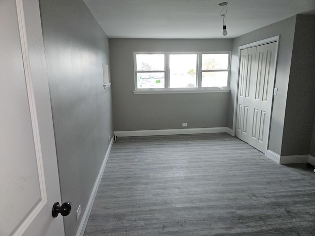 unfurnished bedroom with hardwood / wood-style flooring