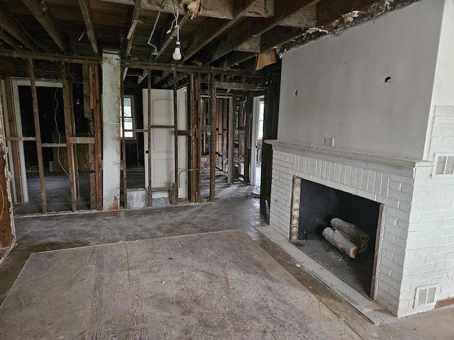 unfurnished living room featuring a brick fireplace