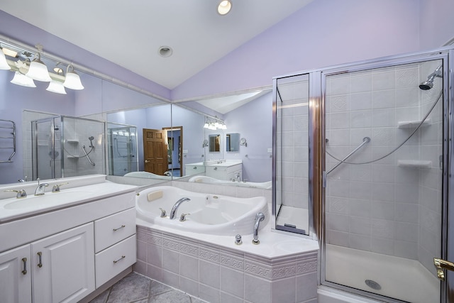 bathroom with tile patterned flooring, vanity, independent shower and bath, and vaulted ceiling