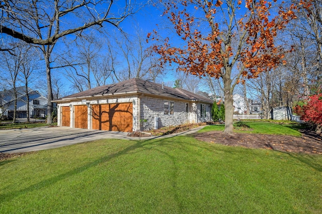 view of side of property featuring a garage and a yard