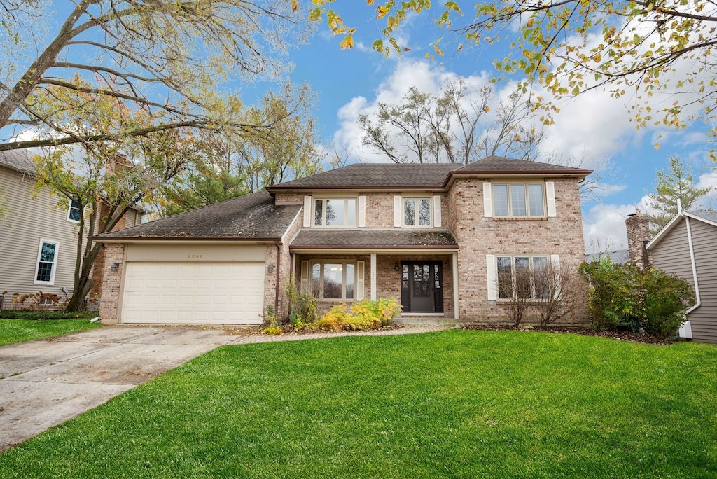 view of front of property with a front yard and a garage