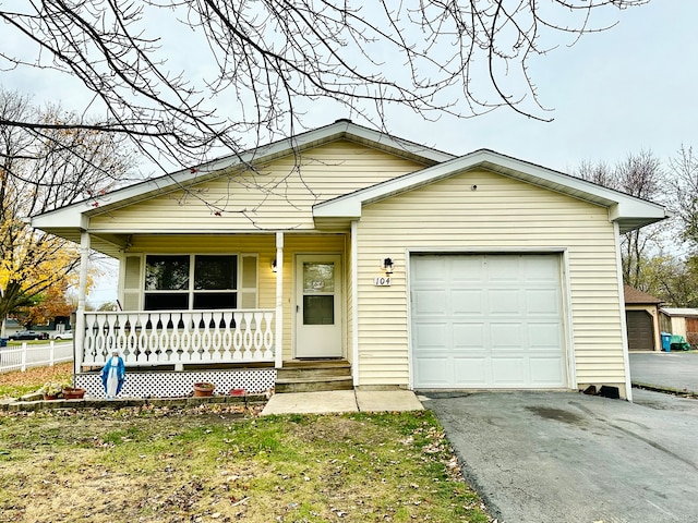 ranch-style home featuring covered porch and a garage