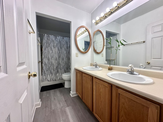 bathroom featuring vanity, toilet, a shower with shower curtain, and hardwood / wood-style flooring