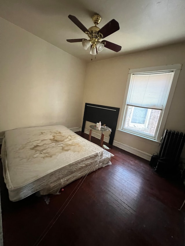 bedroom featuring ceiling fan and dark hardwood / wood-style floors