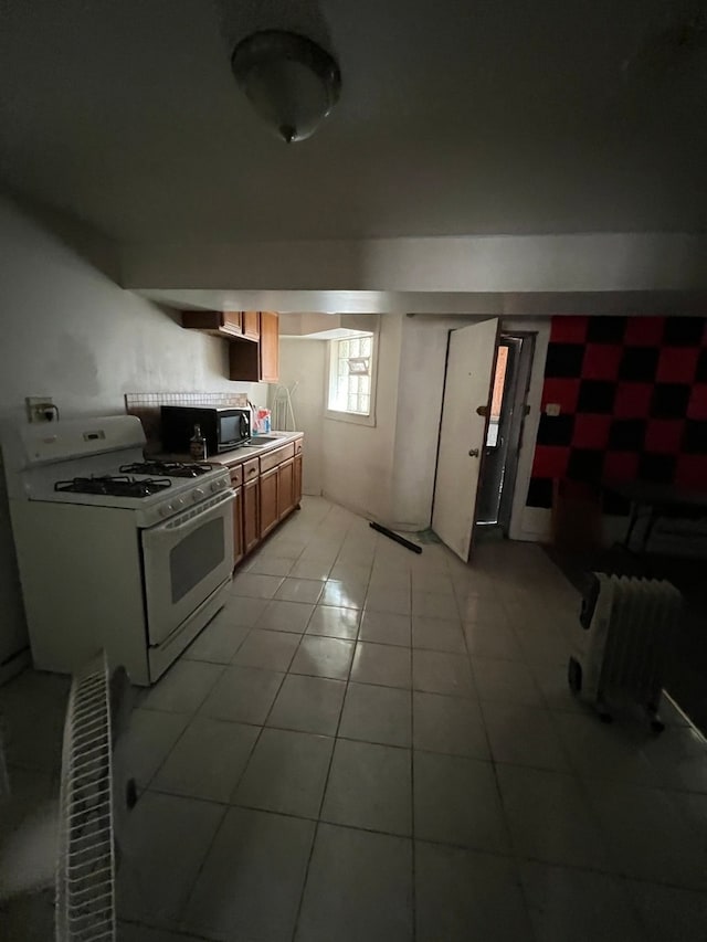 kitchen with gas range gas stove and light tile patterned flooring