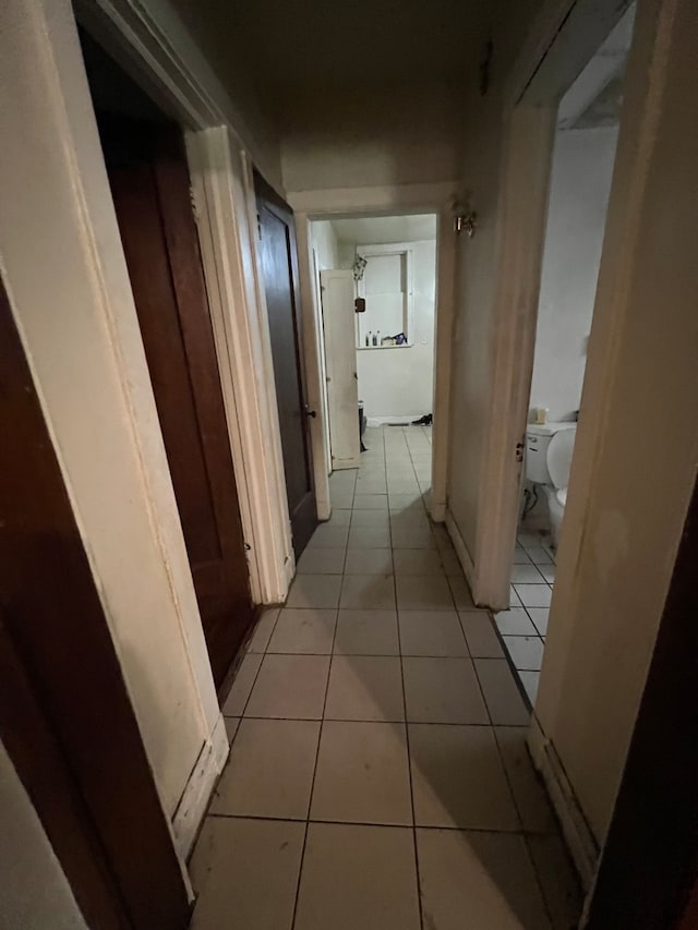 hall with light tile patterned flooring