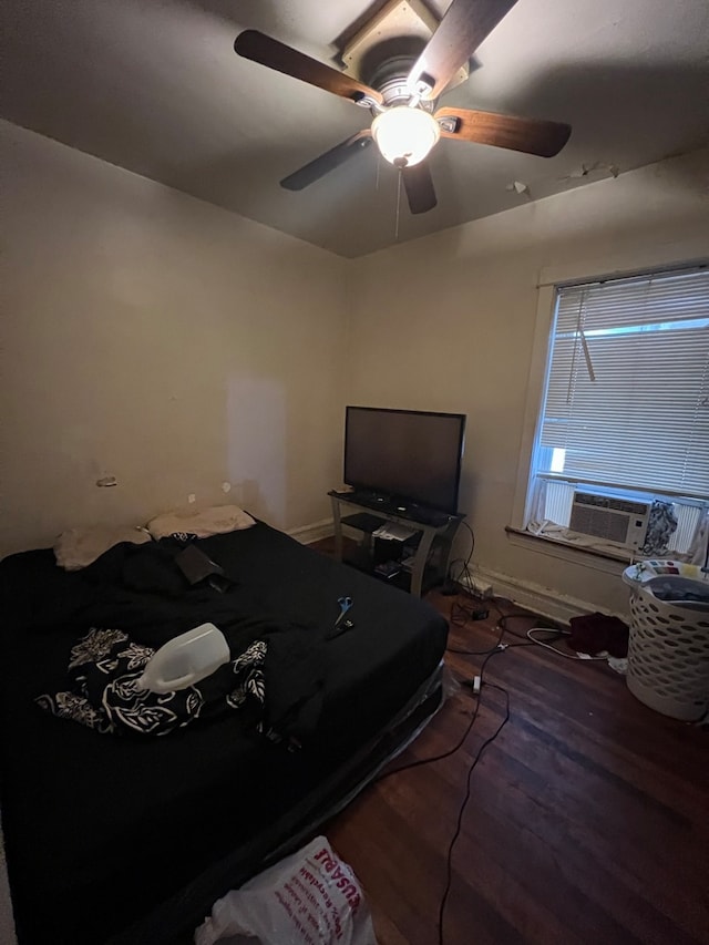 bedroom with ceiling fan, dark hardwood / wood-style flooring, and cooling unit