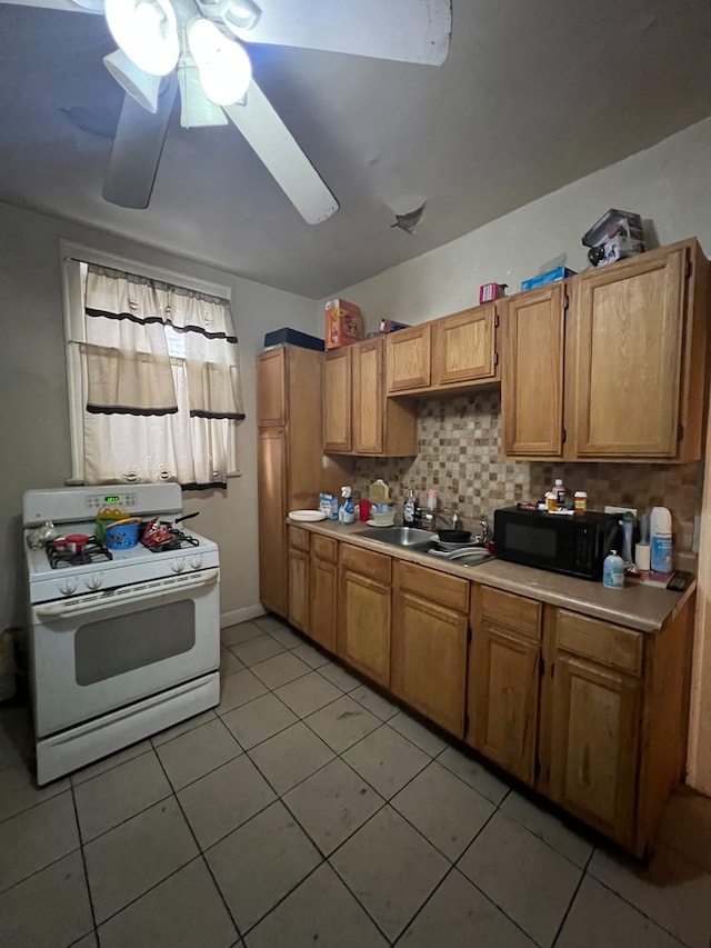 kitchen with decorative backsplash, light tile patterned floors, ceiling fan, and gas range gas stove