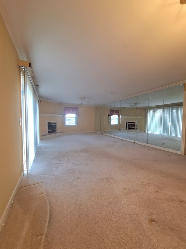 basement with light colored carpet and a wall mounted AC