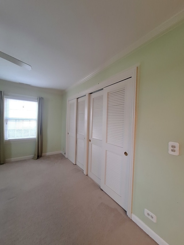 unfurnished bedroom with light colored carpet