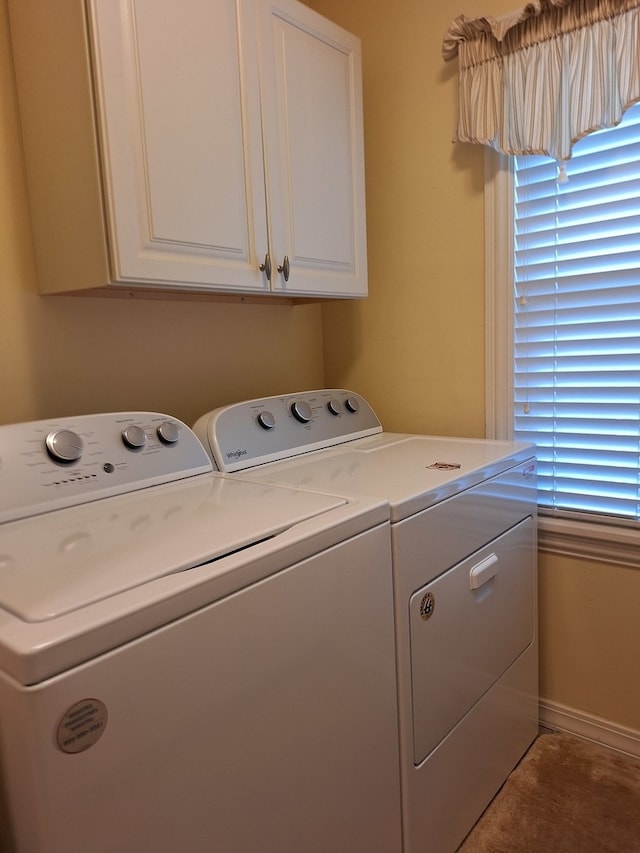 washroom featuring cabinets and separate washer and dryer