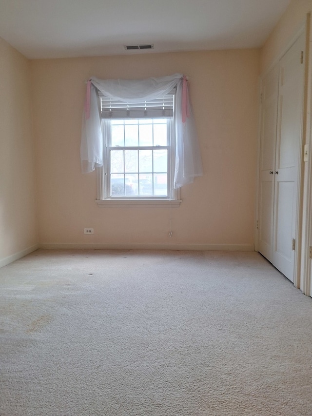 empty room featuring light carpet