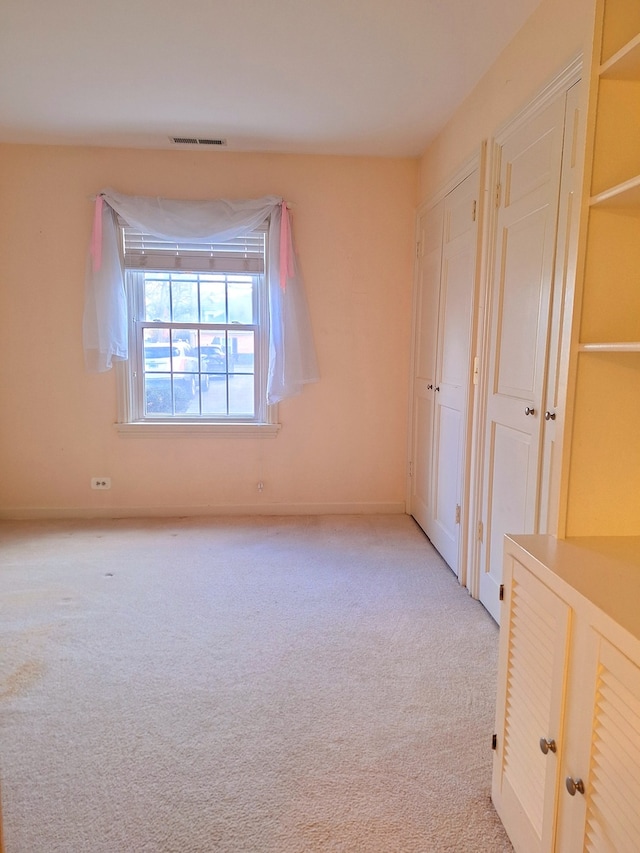 unfurnished bedroom with light carpet