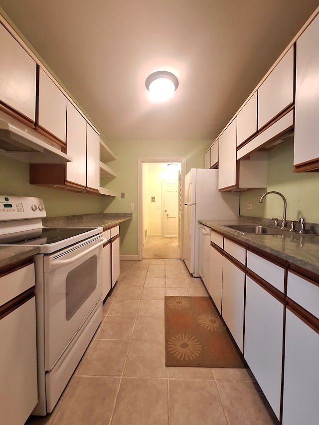 kitchen featuring white range with electric cooktop, white cabinetry, sink, and light tile patterned floors