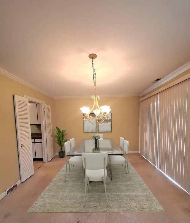 carpeted dining space with an inviting chandelier and ornamental molding