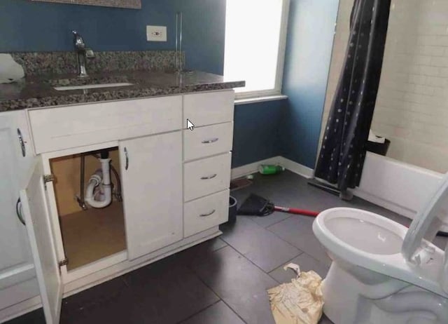 full bathroom featuring tile patterned flooring, vanity, toilet, and shower / tub combo with curtain