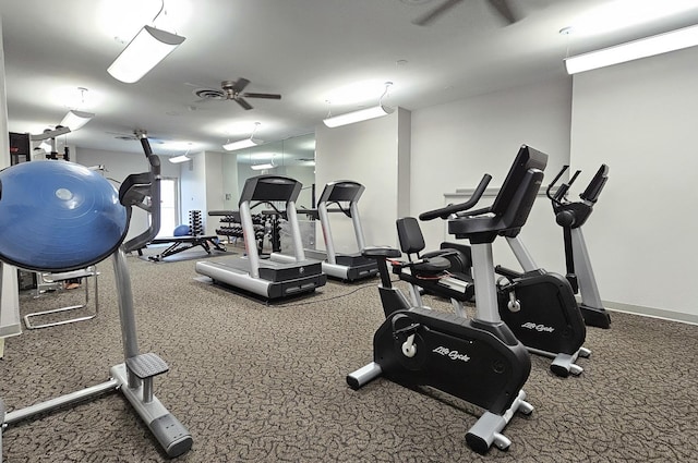 workout area with a ceiling fan and baseboards