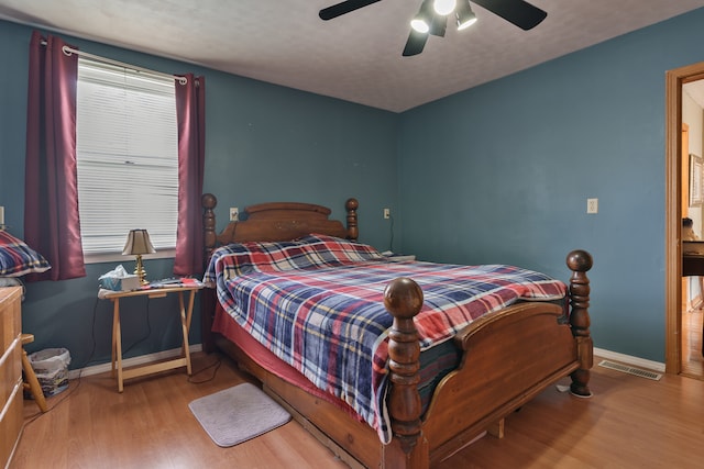 living room with wood-type flooring and ceiling fan