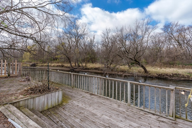 wooden deck featuring a water view