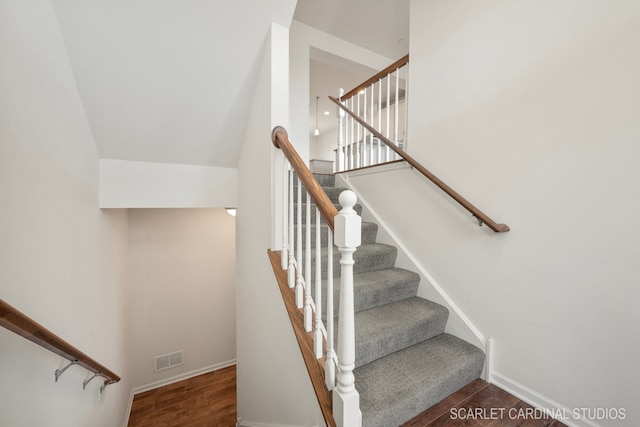 stairs with hardwood / wood-style floors