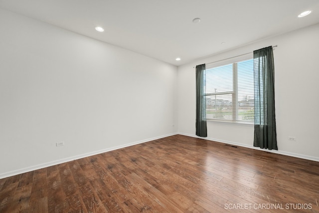 spare room with hardwood / wood-style flooring