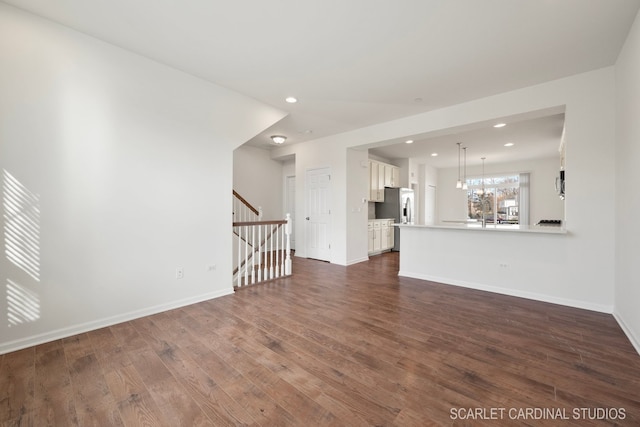 unfurnished living room featuring dark hardwood / wood-style floors