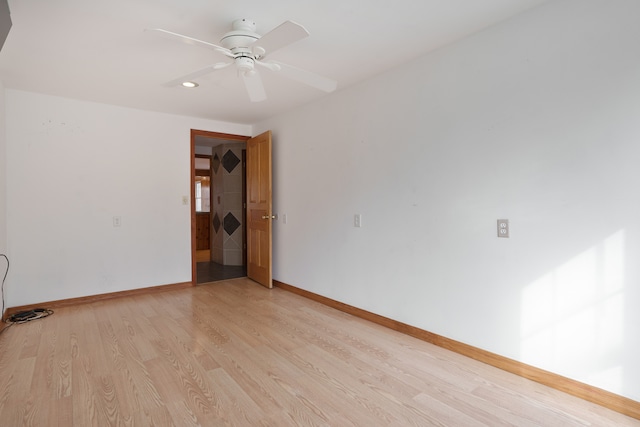 spare room with light hardwood / wood-style flooring and ceiling fan