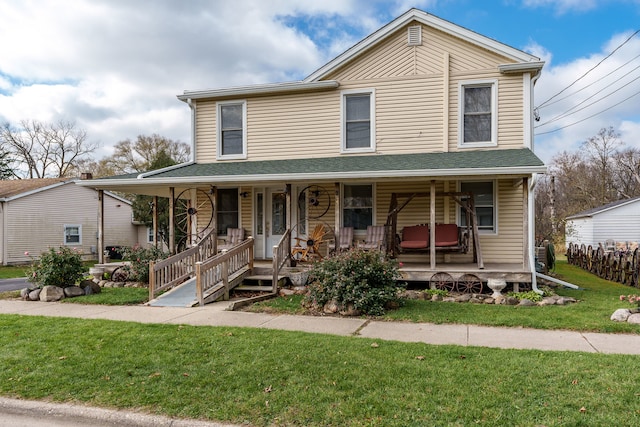 view of front facade with covered porch and a front lawn