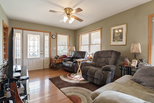 living room with light hardwood / wood-style flooring and ceiling fan