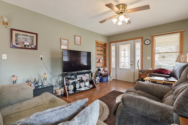 living room with hardwood / wood-style flooring and ceiling fan