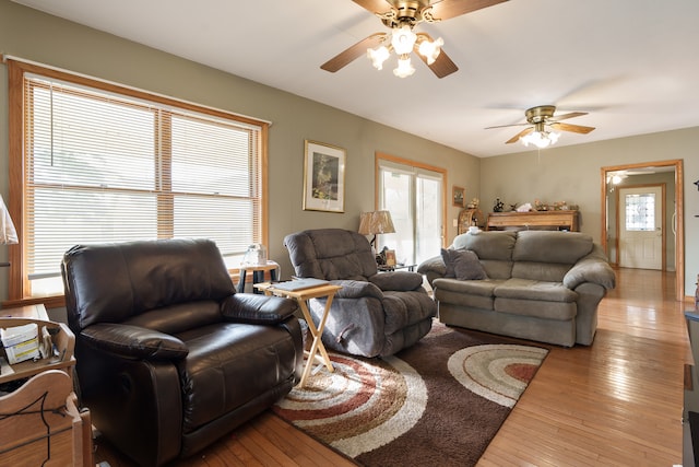 living room featuring ceiling fan and light wood-type flooring