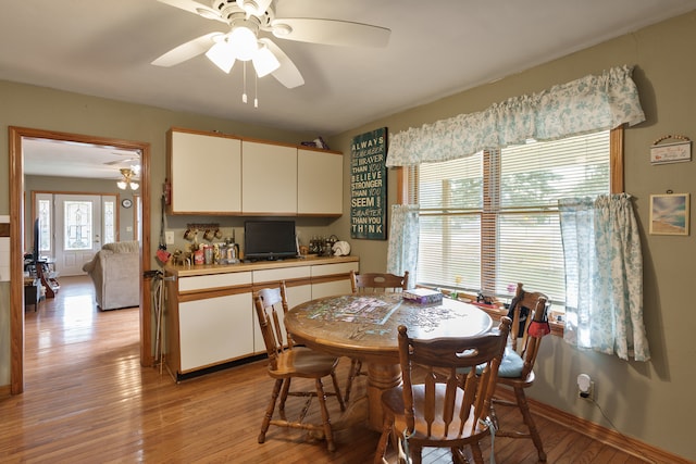 dining room with light hardwood / wood-style floors and ceiling fan