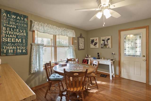 dining space with hardwood / wood-style floors and ceiling fan