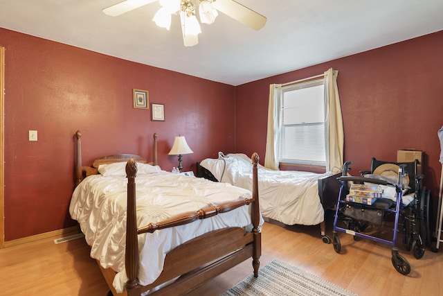 bedroom with ceiling fan and wood-type flooring