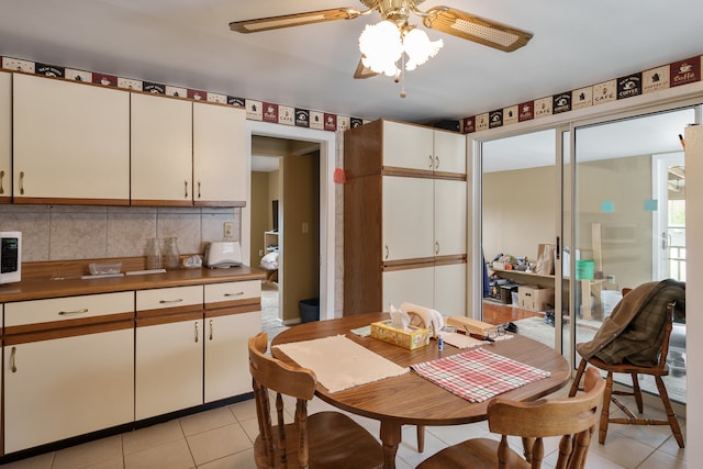 tiled dining space with ceiling fan