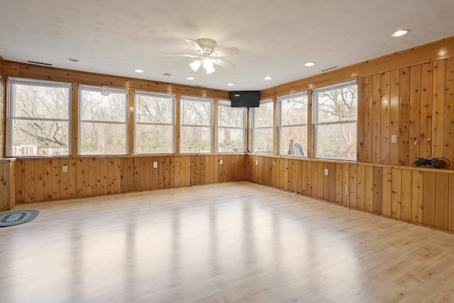 unfurnished sunroom with plenty of natural light and ceiling fan