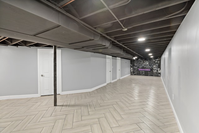 basement featuring light parquet flooring