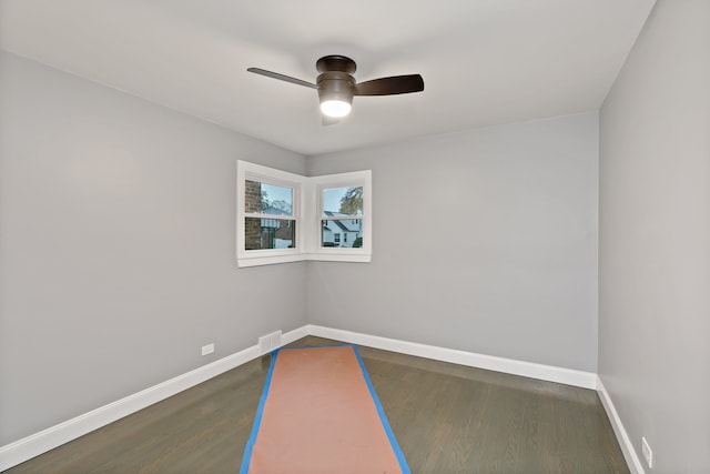 empty room featuring dark hardwood / wood-style floors and ceiling fan