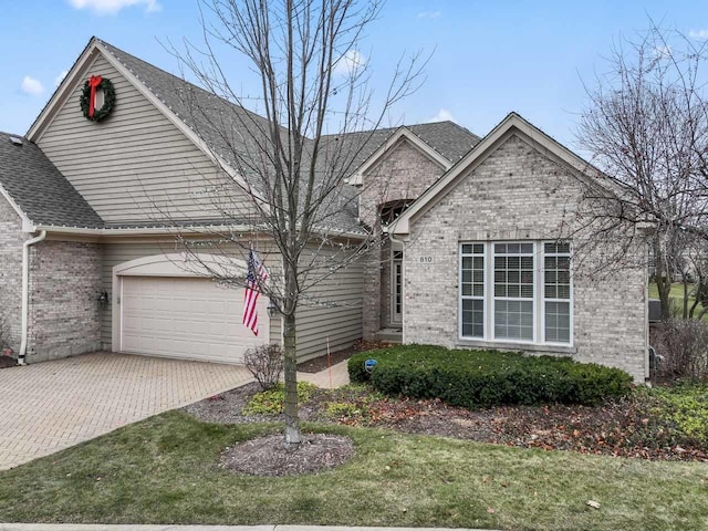 view of front of home with a garage and a front lawn