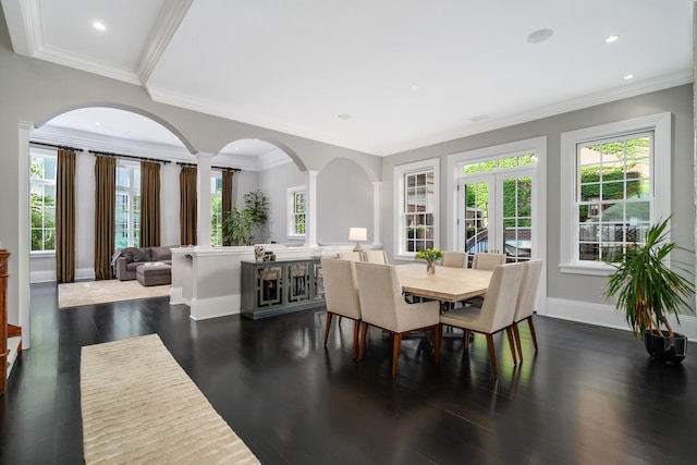 dining space with dark hardwood / wood-style floors, ornamental molding, french doors, and decorative columns
