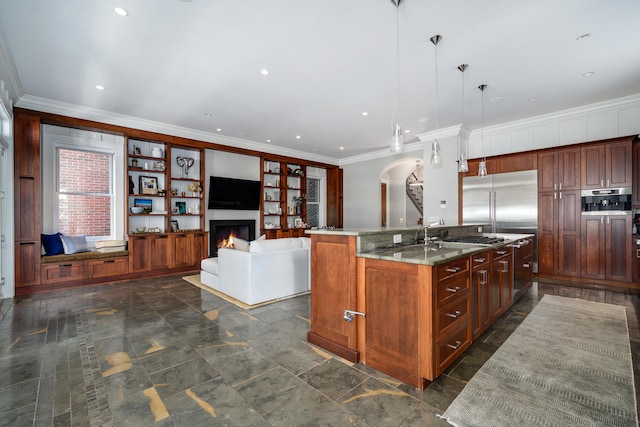 kitchen featuring a kitchen island with sink, stainless steel built in fridge, light stone countertops, ornamental molding, and decorative light fixtures