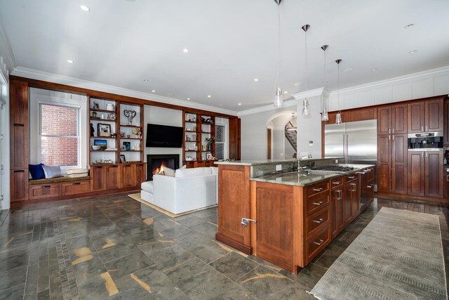 460 W Huron St, Chicago, IL 60654 - kitchen with arched walkways, an island with sink, a warm lit fireplace, ornamental molding, and a sink