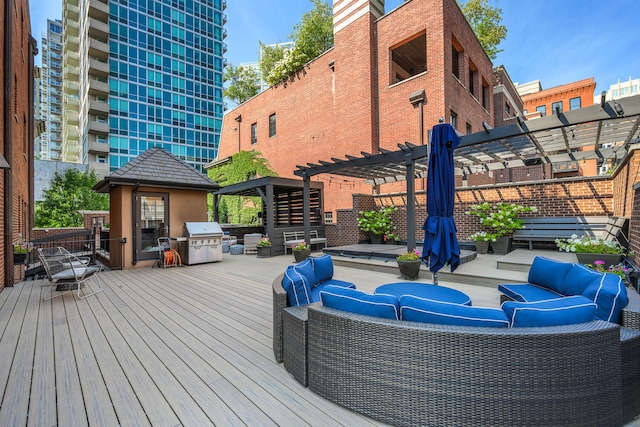 wooden deck featuring outdoor lounge area, a pergola, and area for grilling
