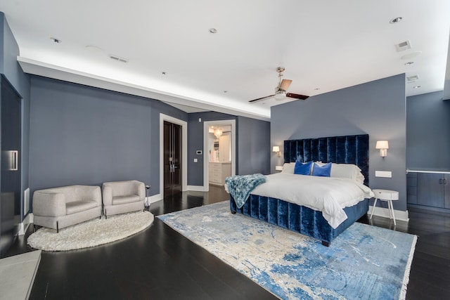 bedroom with ceiling fan, dark wood-type flooring, and ensuite bathroom