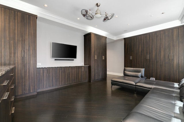 unfurnished living room with dark hardwood / wood-style flooring and ornamental molding