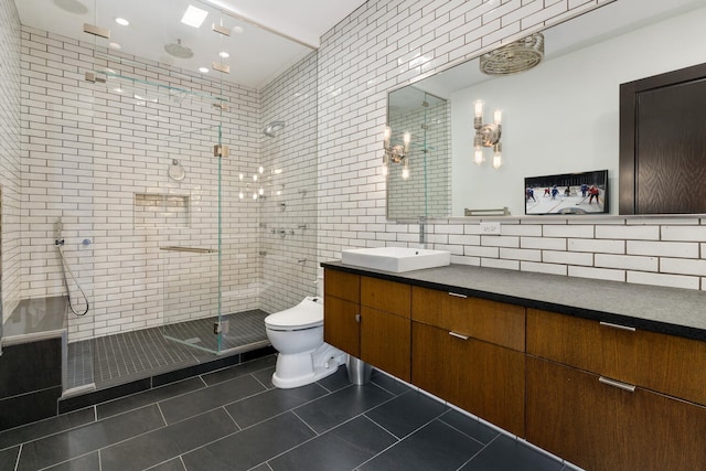 bathroom with vanity, backsplash, tile patterned flooring, toilet, and tiled shower