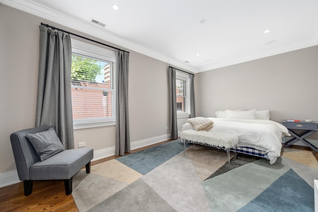 bedroom with light hardwood / wood-style floors and crown molding