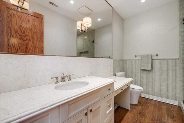 460 W Huron St, Chicago, IL 60654 - full bathroom with tile walls, toilet, a shower with door, vanity, and wood finished floors