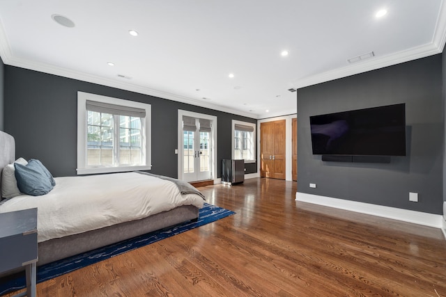 bedroom with multiple windows, wood-type flooring, and ornamental molding