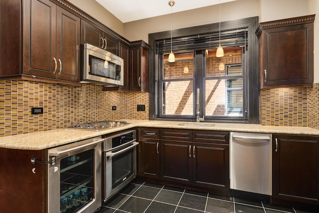 kitchen with hanging light fixtures, tasteful backsplash, dark brown cabinetry, stainless steel appliances, and beverage cooler